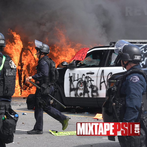 Police Car on Fire from Riot Background